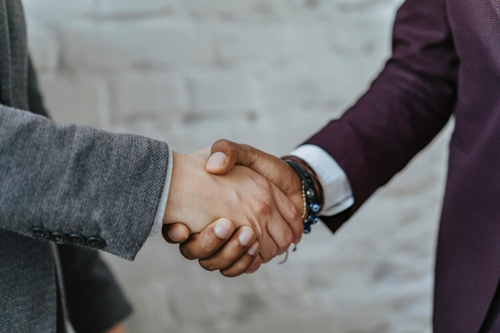 pexels-photo-5313361-5313361 Professional handshake symbolizing cooperation and partnership in a business setting.